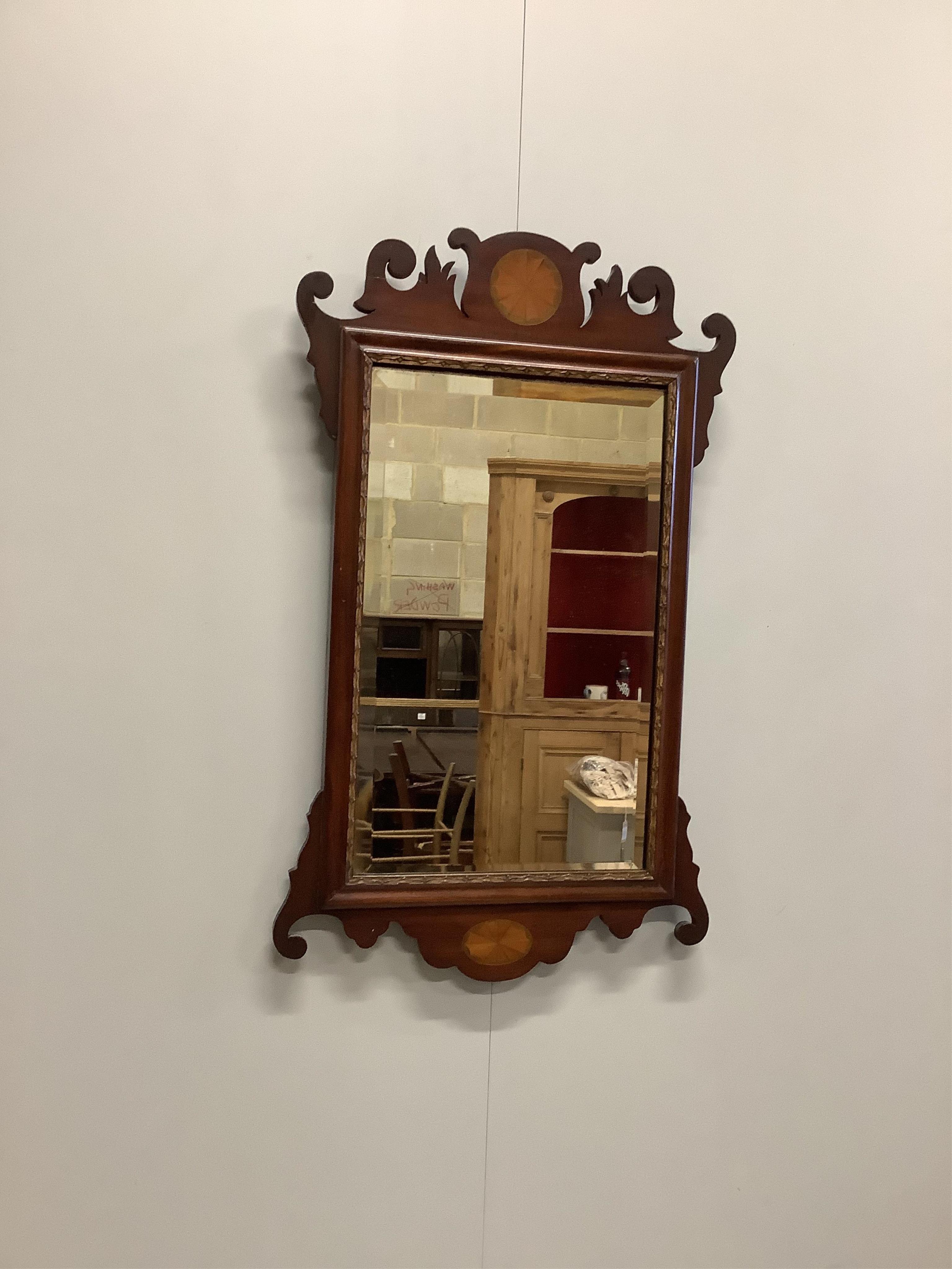 An 18th century walnut toilet mirror, height 43cm, an Edwardian inlaid fret cut wall mirror and an Edwards and Roberts mahogany wall bracket. Condition - fair to good.